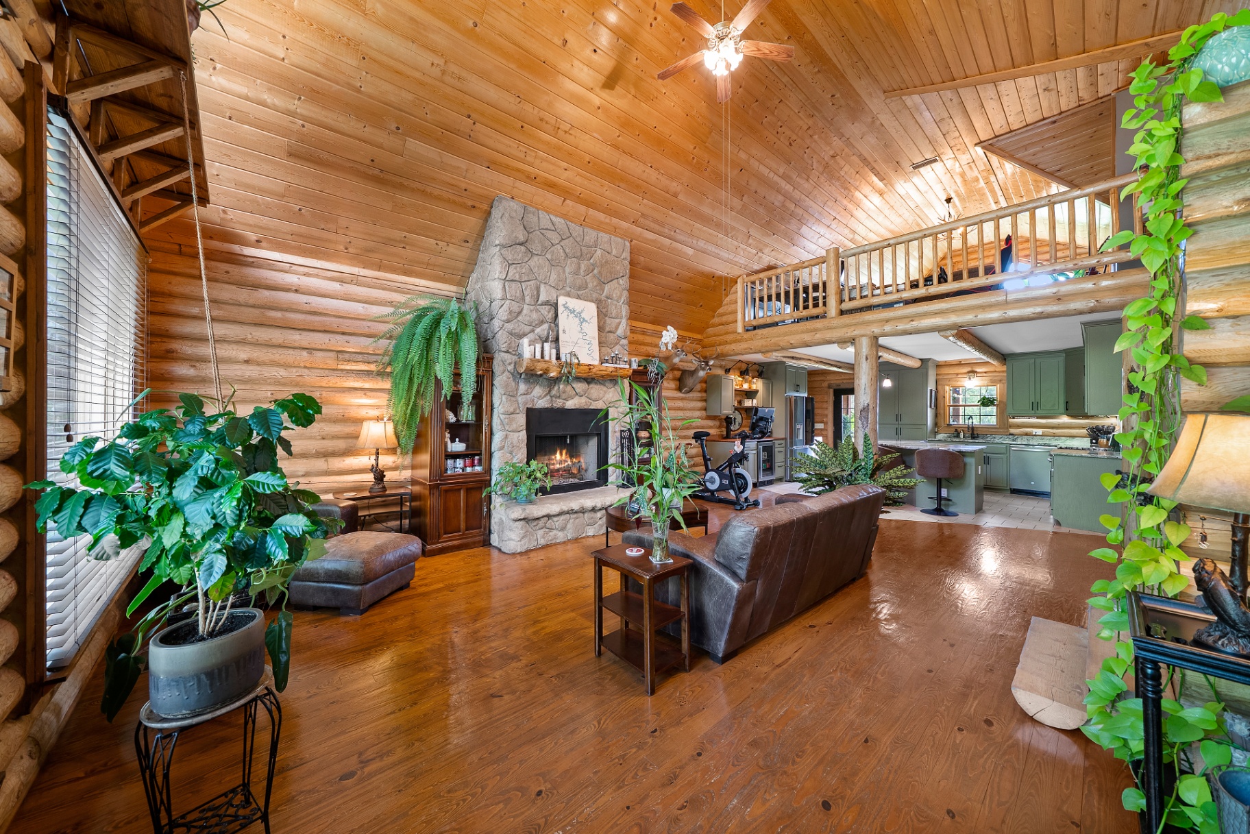 Great room with soaring log walls and stone fireplace