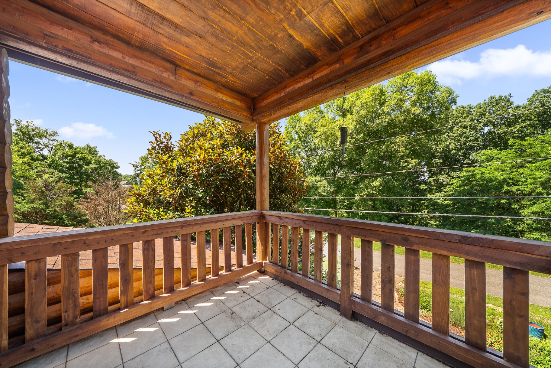 Tile-covered patio outside upper level bedroom