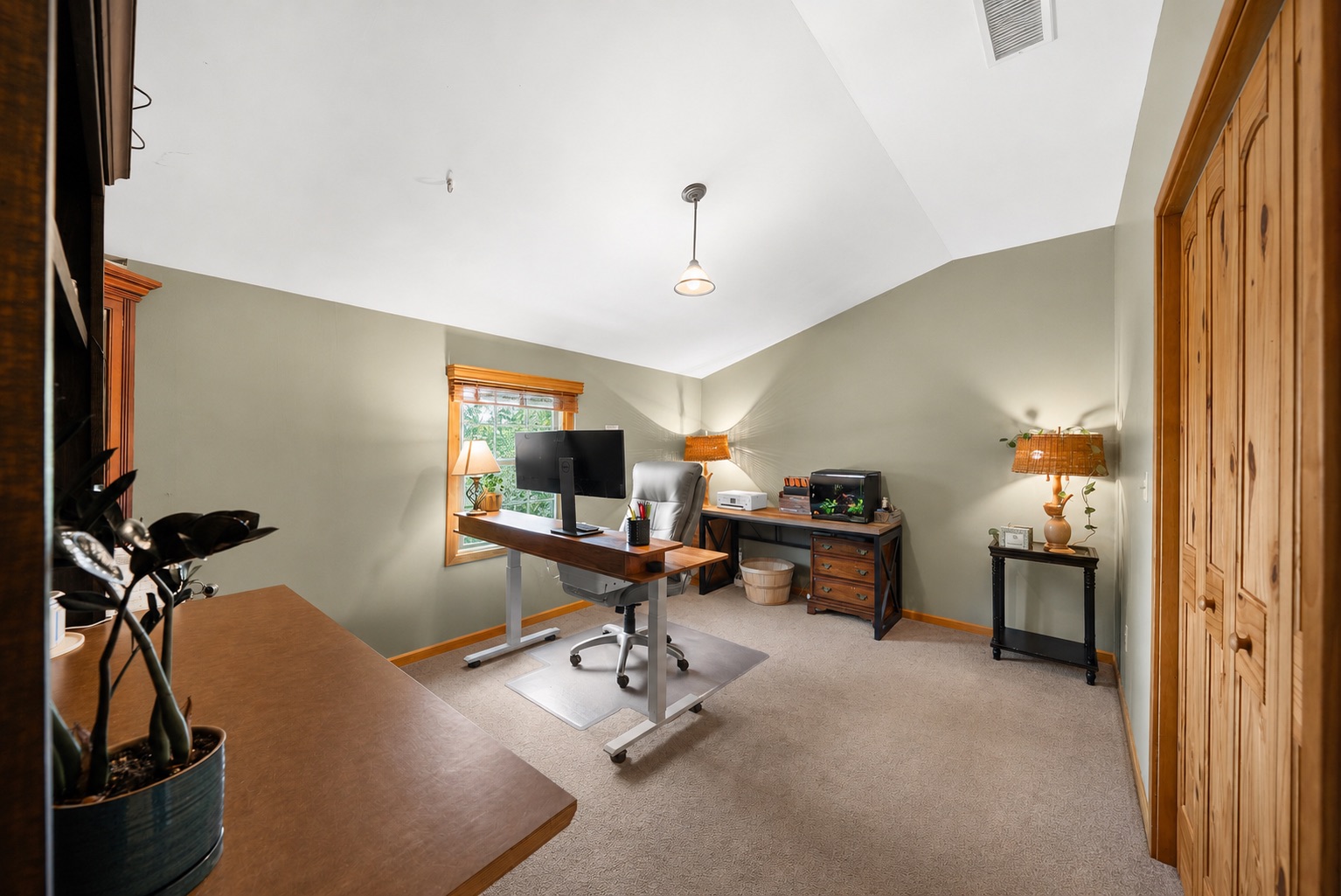 Home office with vaulted ceiling and sage walls